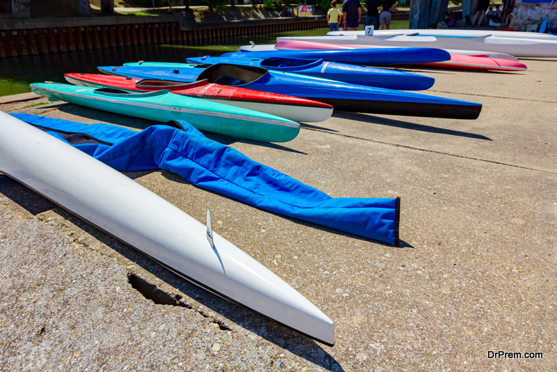 Arranged colorful kayaks on the concrete coast