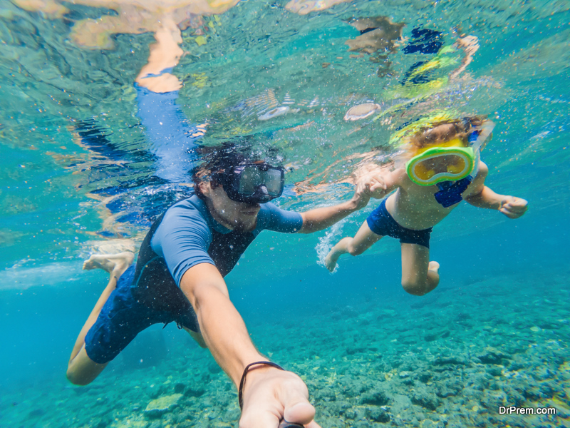 Underwater portrait of father and son snorkeling together