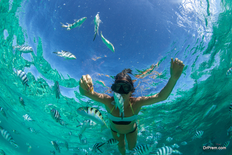 Beautiful girl with black hair has been snorkeling on the island of Mauritius in the Indian Ocean