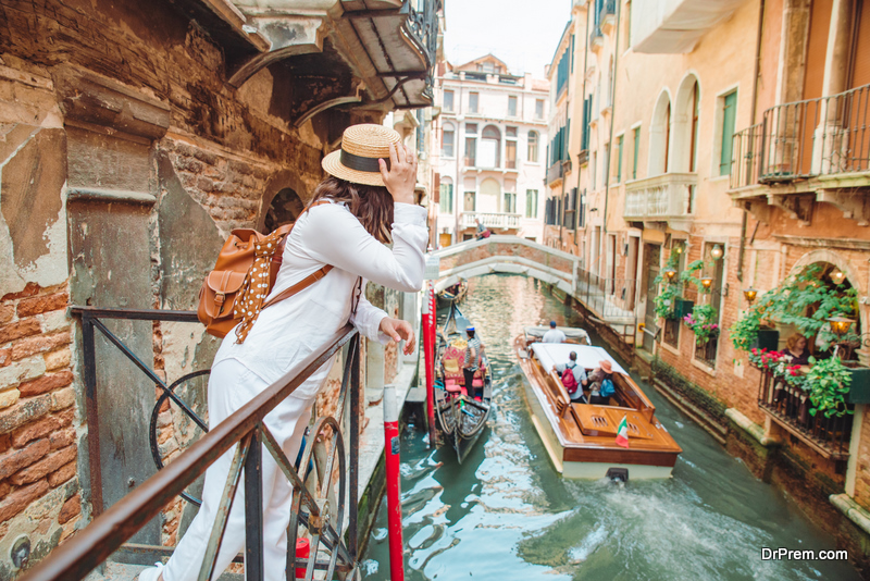 woman looking at canal with gandola summer vacation