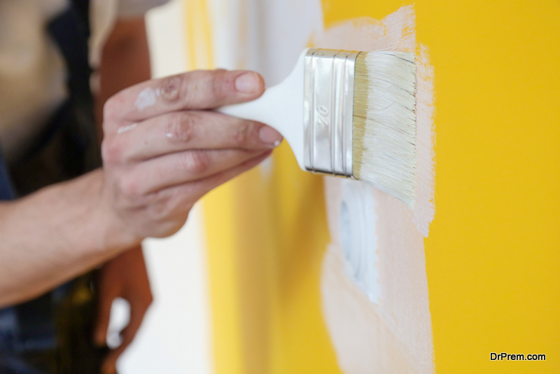Painting-with-white-paint-over-a-yellow-wall