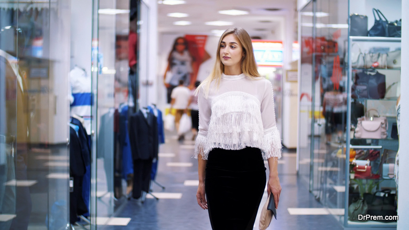 beautiful-blond-woman-walking-down-the-hall-of-shopping-center